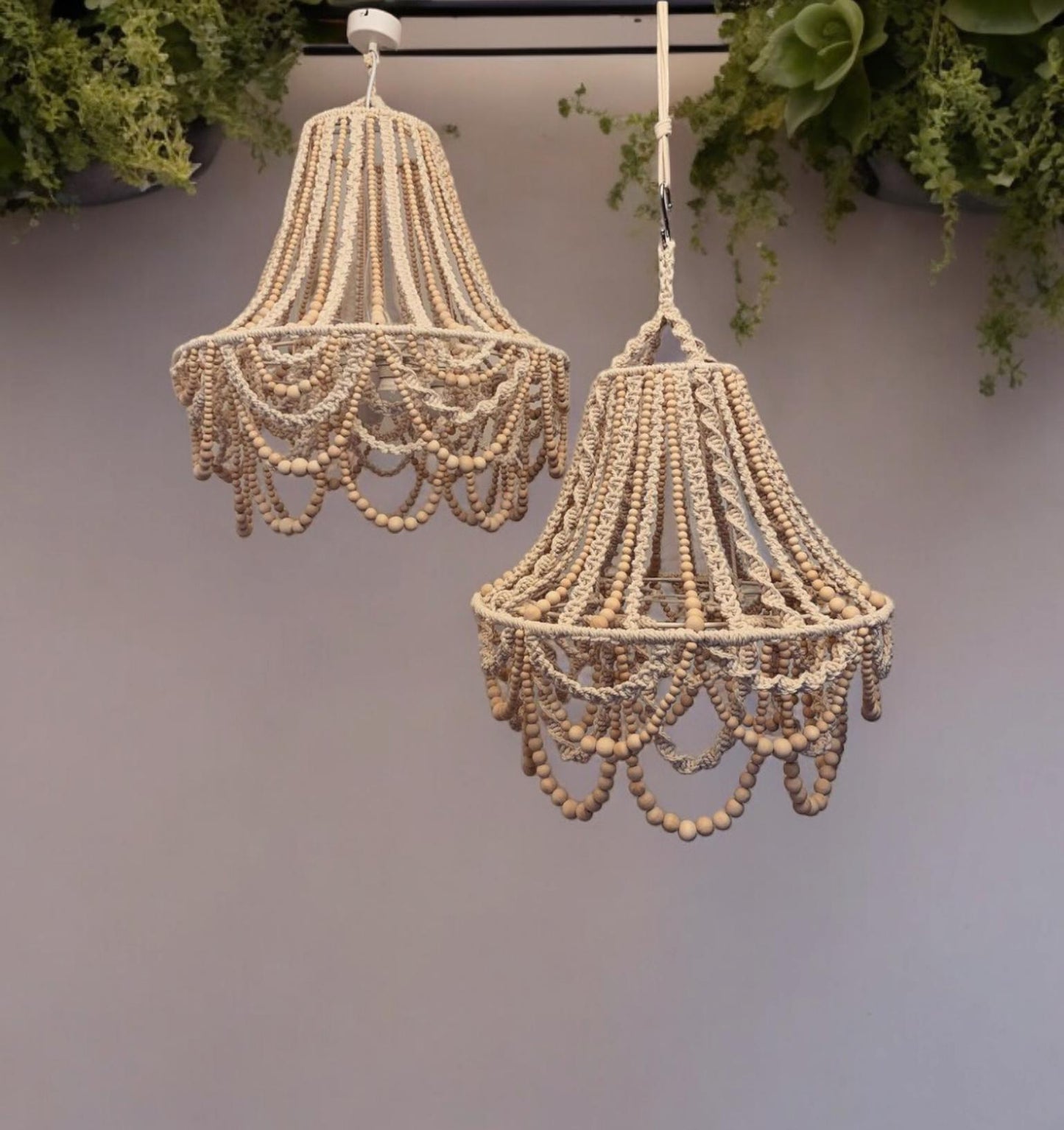 Handmade macramechandelier with a 35cm diameter and 45 cm height, featuring natural wood beads in a bohodesing. the elegant decorative lighting adds a rustic and vintage touch to any room, perfect for creating a warm, natural atmosphere.