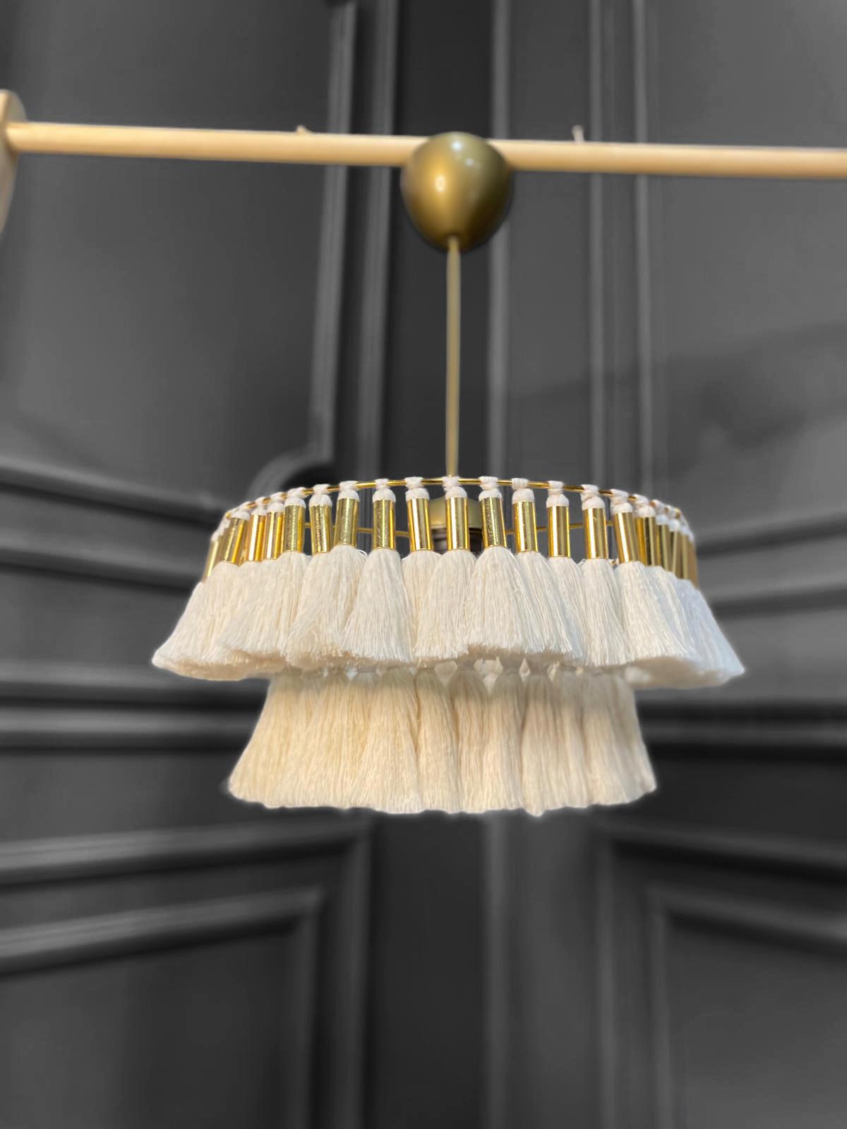 handmade, modern and elegant natural macrame chandelier. This chandelier, measuring 35 cm in diameter, is ideal for creating a warm and stylish atmosphere in interiors. Its gold details perfectly match industrial styles.